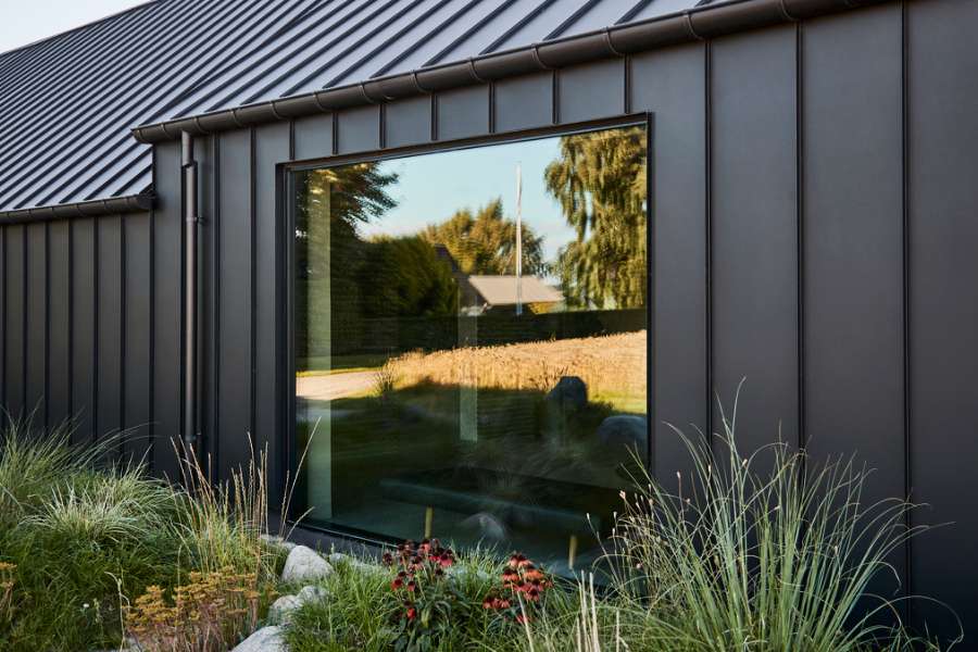 “Royal” door, found in Christiania, now installed in a steel façade, Volstrupvej 63, 9240 Nibe
